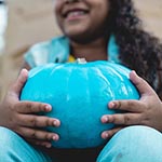 Student with a teal pumpkin